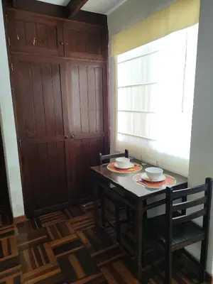 a dining room with a table and two bowls on it at Amplia habitación independiente Larcomar in Lima