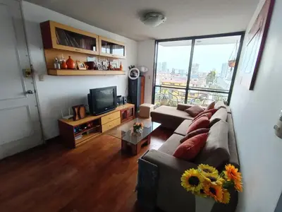 a living room with a couch and a tv at Habitación acogedora amoblada in Lima