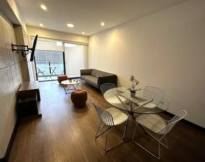 a living room with a table and chairs and a couch at 1 Bedroom Apartment San Isidro Business Zone in Lima