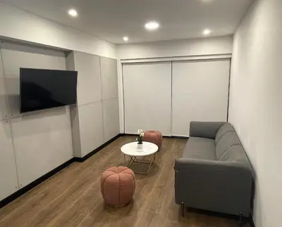 a living room with a couch and a table at 1 Bedroom Apartment San Isidro Business Zone in Lima