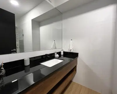 a bathroom with a sink and a mirror at 1 Bedroom Apartment San Isidro Business Zone in Lima