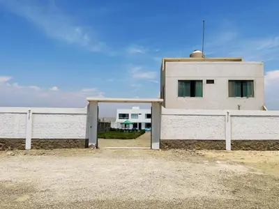 a white building next to a white fence at RELAX Y PISCINA con vista al MAR - DUPLEX in Cerro Azul