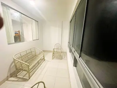 a living room with two chairs and a large flat screen tv at RELAX Y PISCINA con vista al MAR - DUPLEX in Cerro Azul