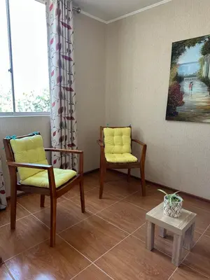 a waiting room with two chairs and a table at Casita en Ica con piscina in Ica