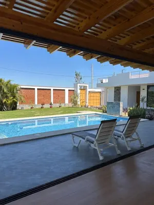 a patio with two chairs and a swimming pool at Casita en Ica con piscina in Ica