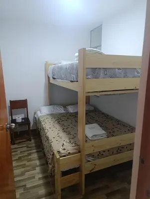 a bedroom with two bunk beds in a room at Casa Hamuys - Ica in Ica
