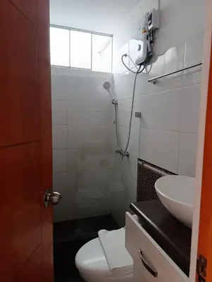 a bathroom with a shower and a toilet and a sink at Casa Hamuys - Ica in Ica