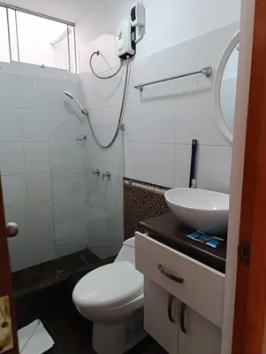 a bathroom with a toilet and a sink at Casa Hamuys - Ica in Ica