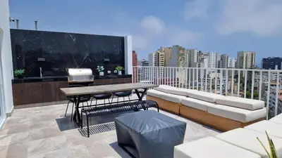 a living room with a couch and a large screen at Beautiful Duplex in the Heart of Miraflores in Lima