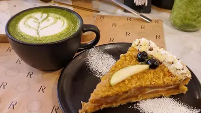 a plate with a piece of cake and a cup of coffee at Beautiful Duplex in the Heart of Miraflores in Lima