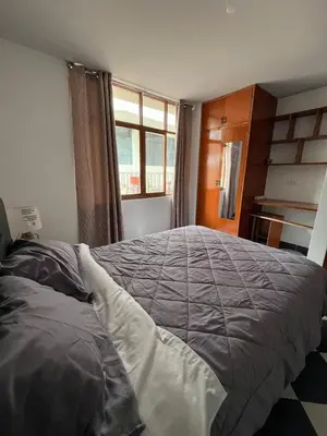 a bedroom with a large bed and a window at Allyu Wasi-Chanka in Andahuaylas