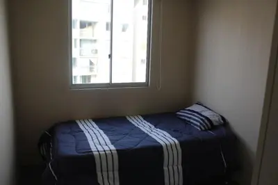 a bed in a room with a window at Cozy Furnished Brand New Apartment