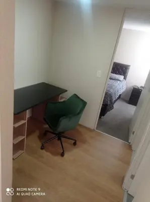 a desk and a chair in a room with a bed at Cozy Furnished Brand New Apartment