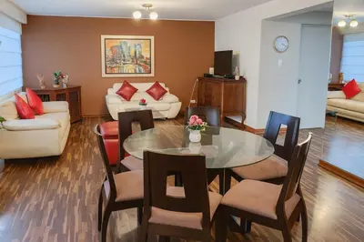 a living room with a table and chairs at Bella vista al mar y Larcomar - Miraflores in Lima