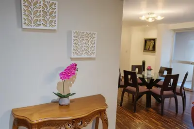 a living room with a table and a dining room at Bella vista al mar y Larcomar - Miraflores in Lima
