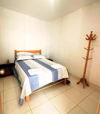 a bedroom with a bed with a cross on the wall at RELAX Y PISCINA con vista al MAR - FLAT in Cerro Azul