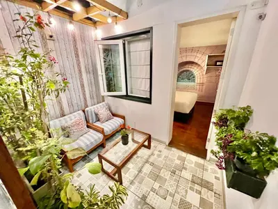 a living room with a couch and some plants at La Casa del Viajero in Lima