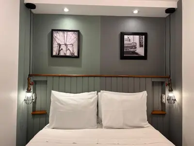 a bedroom with a bed with two pictures on the wall at La Casa del Viajero in Lima