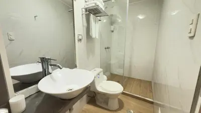 a bathroom with a sink and a toilet and a shower at La Casa del Viajero in Lima