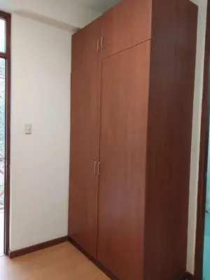 a large wooden cabinet in the corner of a room at Fundo Hotel Ayarpongo in Churín