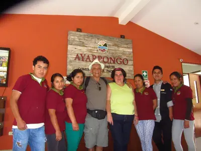 a group of people posing for a picture in a room at Fundo Hotel Ayarpongo in Churín