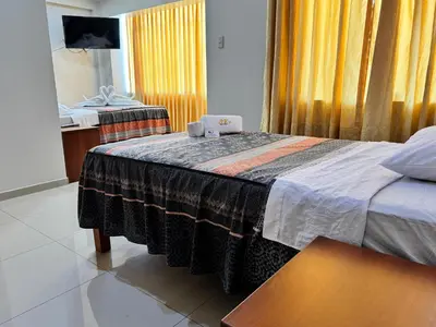 a hotel room with a bed and a mirror at Hotel AK7 in Nazca