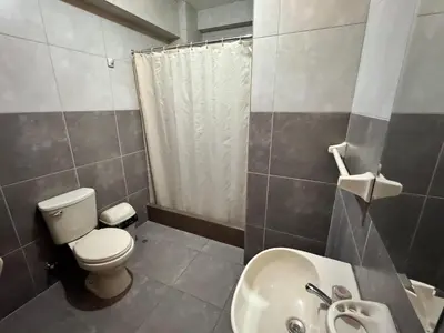 a small bathroom with a toilet and a sink at Hotel AK7 in Nazca