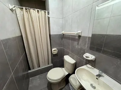 a bathroom with a toilet and a sink and a shower at Hotel AK7 in Nazca