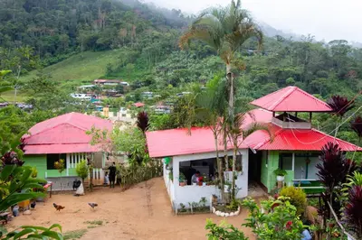 a group of houses with red roofs on a mountain at Hospedaje EL EDEN DE DON AYDEN in Satipo