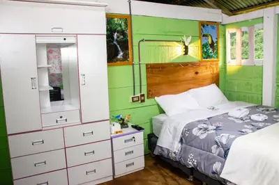 a bedroom with a bed and a dresser at Hospedaje EL EDEN DE DON AYDEN in Satipo