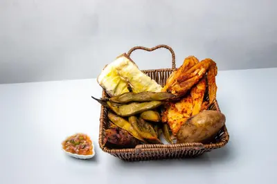 a basket of bread and vegetables on a table at Hospedaje EL EDEN DE DON AYDEN in Satipo