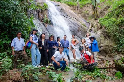 a group of people standing in front of a waterfall at Hospedaje EL EDEN DE DON AYDEN in Satipo