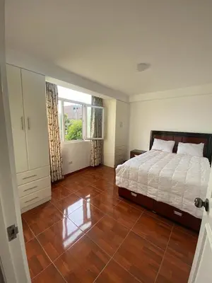 a bedroom with a bed and a wooden floor at Beautiful Complete Apartment in Lima