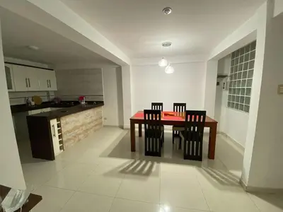 a kitchen with a table and chairs in a room at Beautiful Complete Apartment in Lima