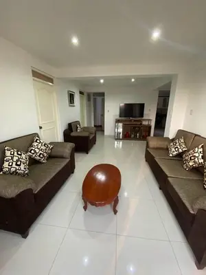 a living room with two couches and a coffee table at Beautiful Complete Apartment in Lima