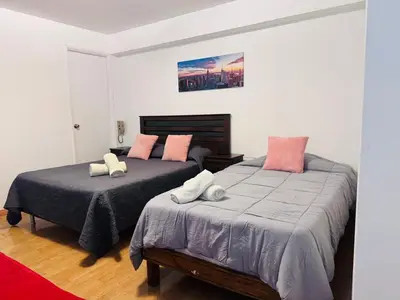 a bedroom with two beds with pillows on them at Monterrico Polo Aparts 6 - DPTO CON 3 CAMAS FRENTE EMBAJADA USA in Lima