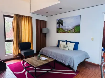 a bedroom with a bed and a table and a chair at Monterrico Polo Aparts 6 - DPTO CON 3 CAMAS FRENTE EMBAJADA USA in Lima
