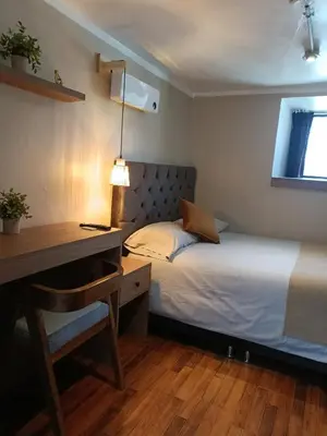 a bedroom with a bed and a desk and a desk at Apartamento Céntrico in Cusco