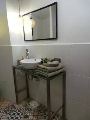 a bathroom with a sink and a mirror at Apartamento Céntrico in Cusco
