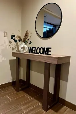 a welcome sign on a table with a mirror at Apartamento Céntrico in Cusco