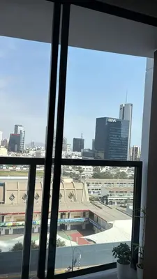 a view of a city skyline from a window at Tu refugio en Lima, moderno y céntrico in Lima