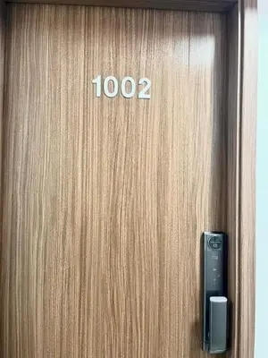 a close up of a wooden door with a phone on it at Tu refugio en Lima, moderno y céntrico in Lima