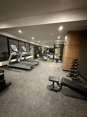 a gym with a row of treadmills and a bench at Tu refugio en Lima, moderno y céntrico in Lima