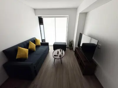 a living room with a couch and a tv at Premium apartment in Miraflores with rooftop pool in Lima