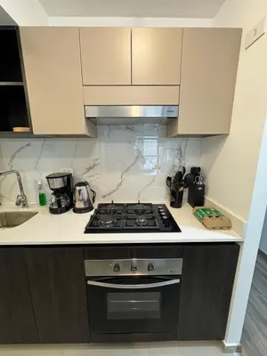 a kitchen with a stove top oven next to a sink at Premium apartment in Miraflores with rooftop pool in Lima
