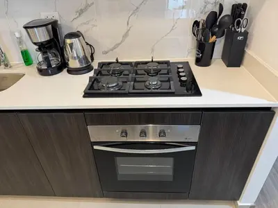 a stove top oven sitting on top of a kitchen counter at Premium apartment in Miraflores with rooftop pool in Lima