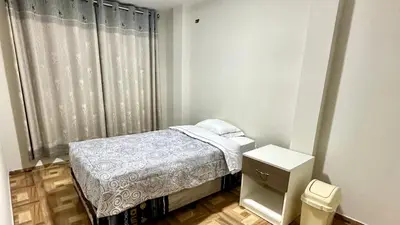 a small bedroom with a bed and a window at Habitación privada a 20 min del aeropuerto de Lima in Lima