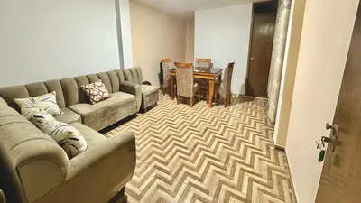 a living room with a couch and a table at Habitación privada a 20 min del aeropuerto de Lima in Lima