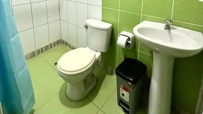 a bathroom with a toilet and a sink at Habitación privada a 20 min del aeropuerto de Lima in Lima