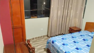a bedroom with a bed and a window at Hospedaje El Sureño in Satipo